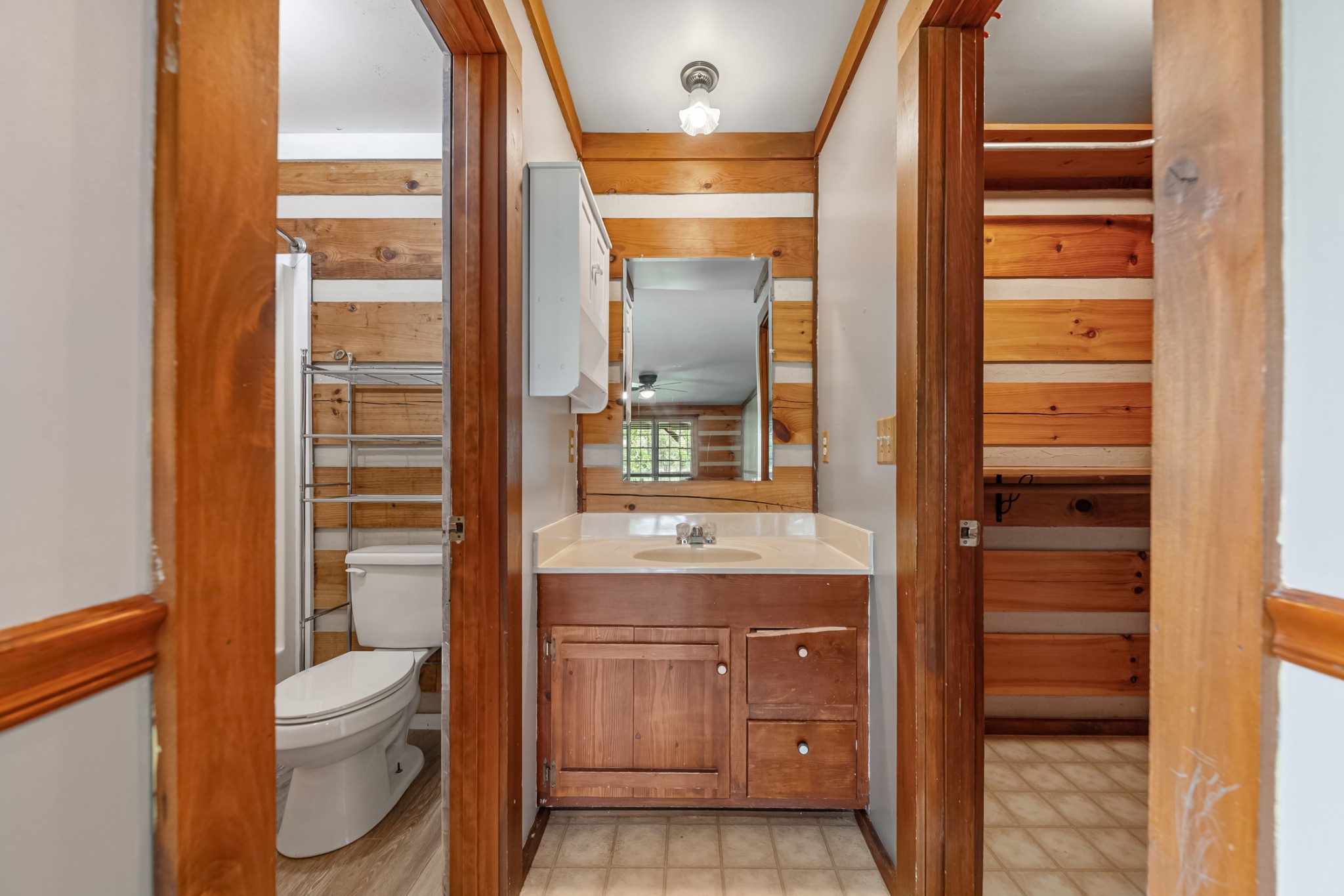 2151 Maysville Road Dickson, TN 37055 - Photo 55 of 98 a bathroom with a granite countertop toilet a sink and a large mirror