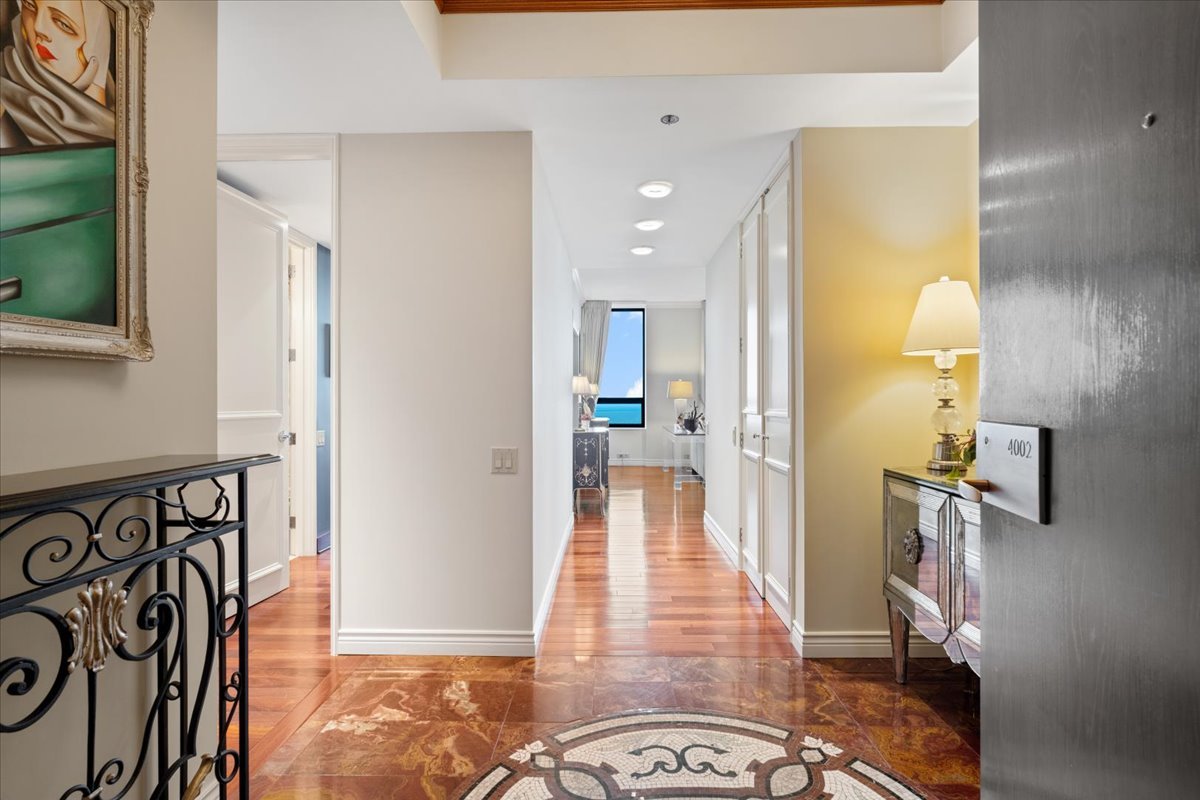 180 East Pearson Street, Unit 4002 Chicago, IL 60611 - Photo 6 of 40 a view of a hallway with wooden floor and a living room