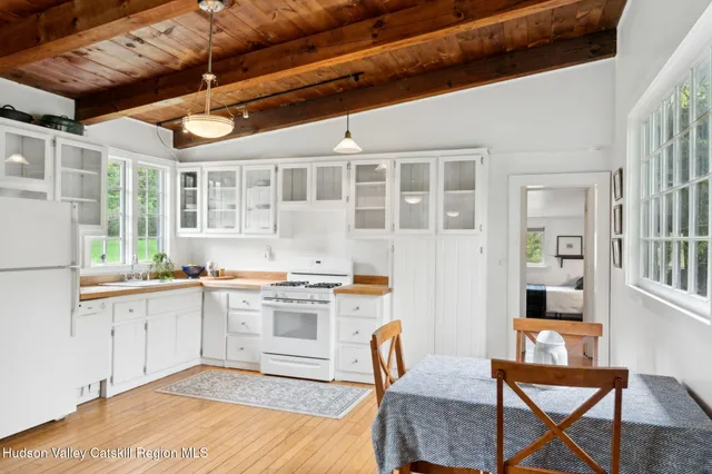 a view of a room that has a window and wooden floor