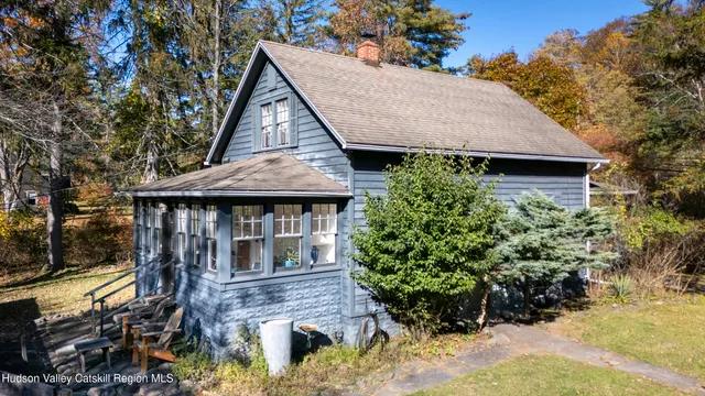a front view of a house with a yard and potted plants