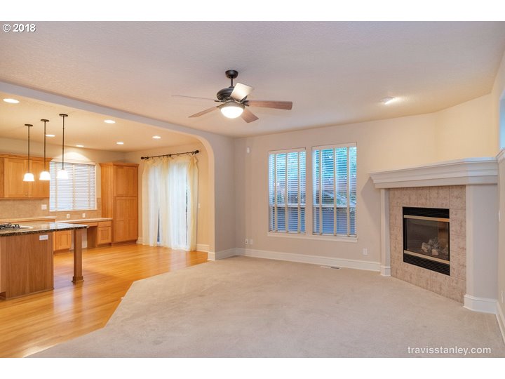 4636 Northwest Corazon Terrace Portland, OR 97229 - Photo 4 of 18 a view of an empty room with a fireplace and a window