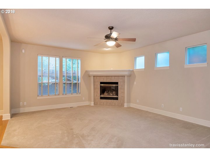 4636 Northwest Corazon Terrace Portland, OR 97229 - Photo 8 of 18 a view of an empty room with a fireplace and a window