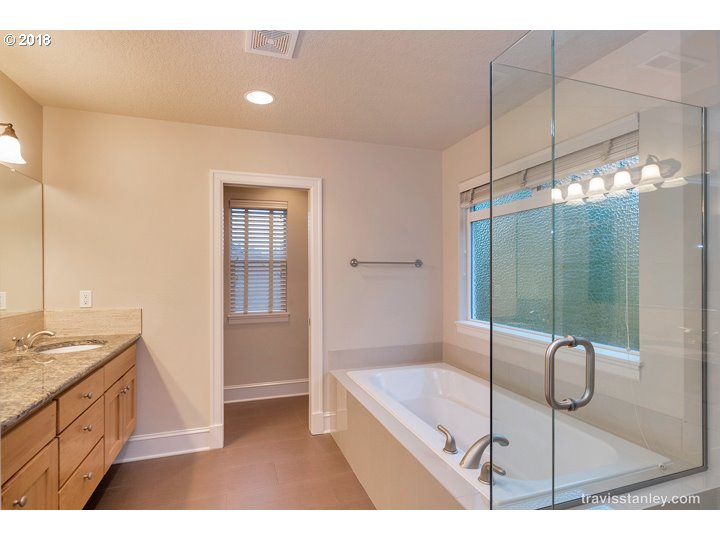 4636 Northwest Corazon Terrace Portland, OR 97229 - Photo 10 of 18 a bathroom with a granite countertop sink a mirror and shower