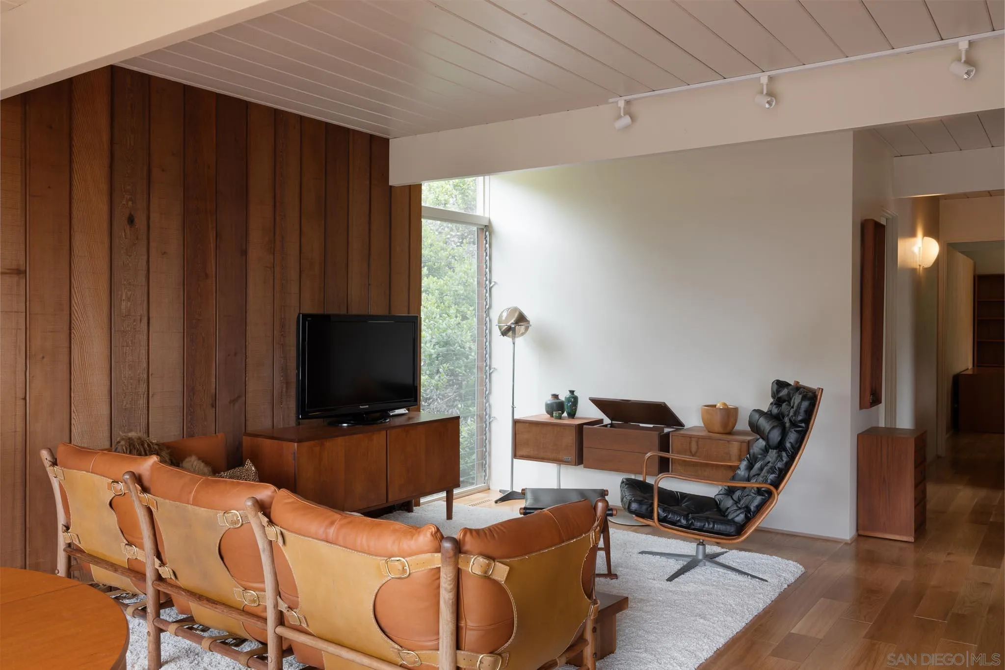 1945 Balboa Avenue Del Mar, CA 92014 - Photo 12 of 25 a living room with furniture a flat screen tv and wooden floor