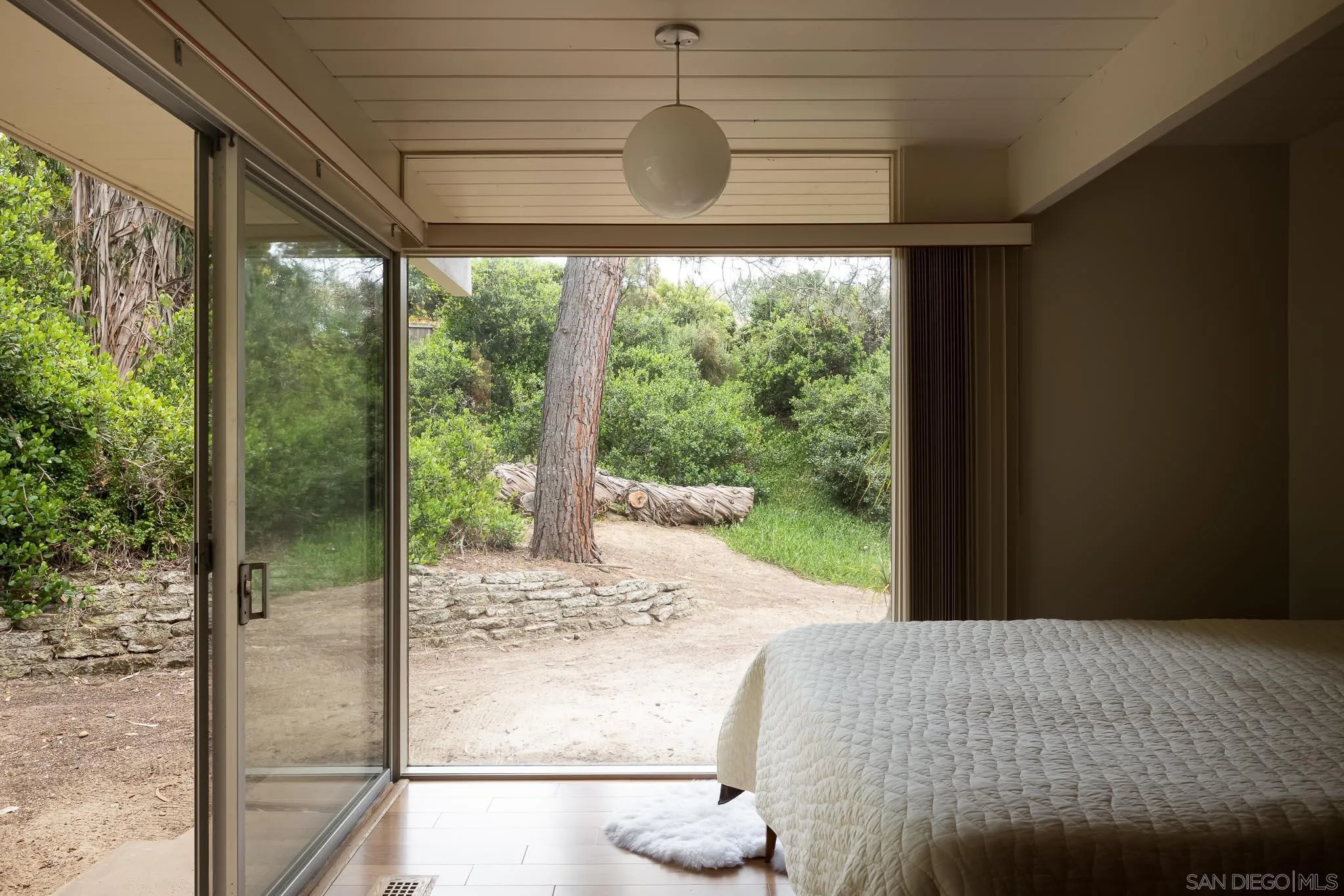1945 Balboa Avenue Del Mar, CA 92014 - Photo 15 of 25 a bedroom with a bed and a large window