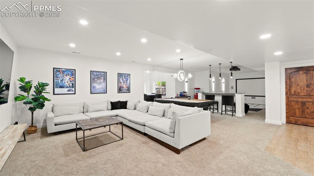 13625 Random Ridge View Colorado Springs, CO 80921 - Photo 24 of 50 Living area with recessed lighting, light colored carpet, and a chandelier