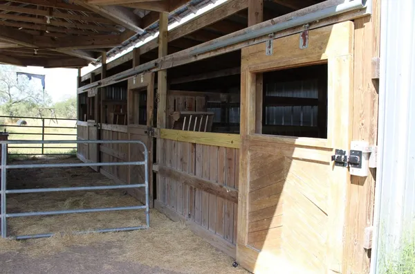 a view of a house with wooden fence