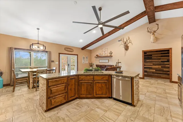 a kitchen with stainless steel appliances granite countertop a sink and cabinets