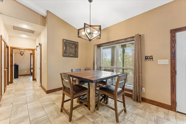 a view of a dining room with furniture and window