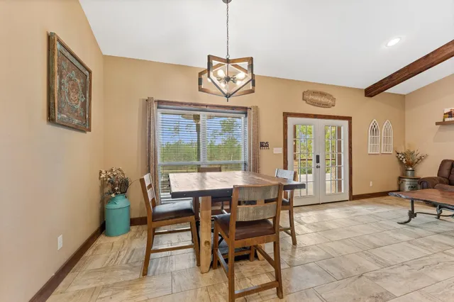 a dining room with furniture and window