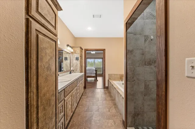 a bathroom with a glass shower door and a sink