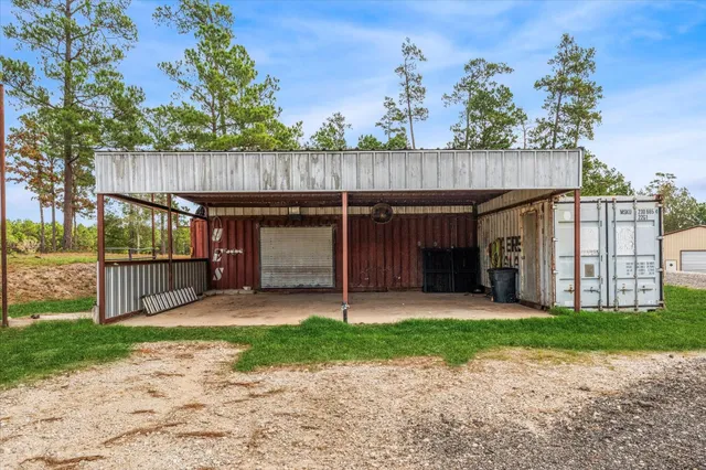 a view of a house with a small yard and wooden fence