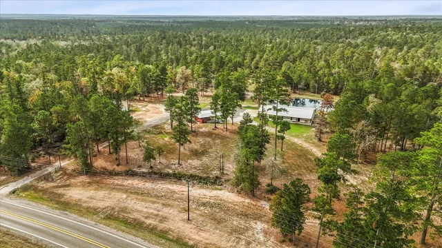 a view of a yard with wooden fence