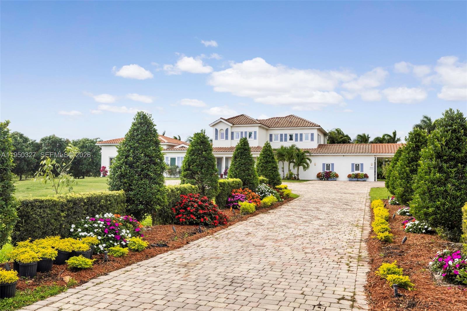 34650 Southwest 218th Avenue Homestead, FL 33034 - Photo 1 of 52 a view of a garden with a lot of flower plants and wooden fence