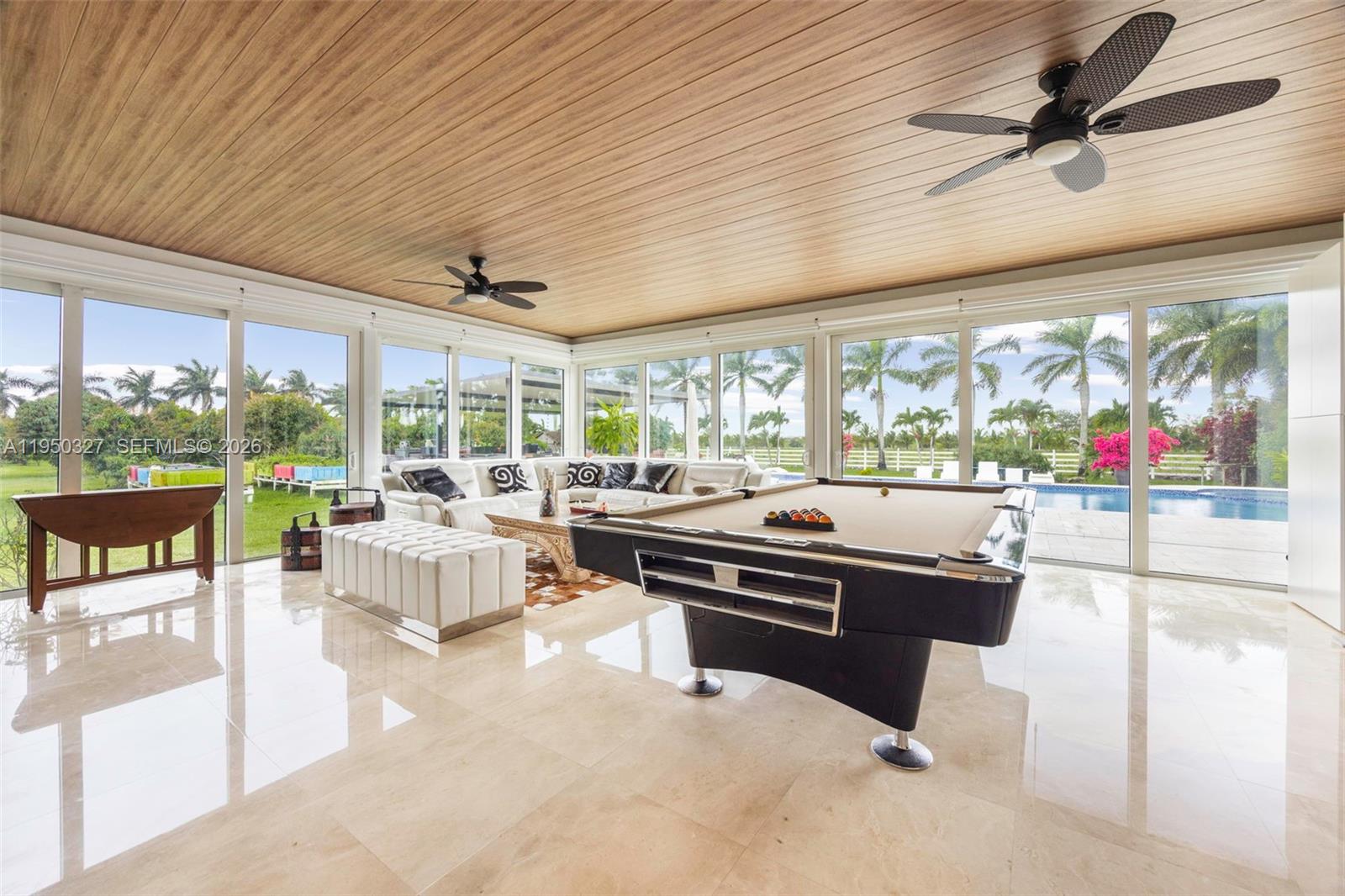 34650 Southwest 218th Avenue Homestead, FL 33034 - Photo 12 of 52 a living room with patio furniture and a floor to ceiling window