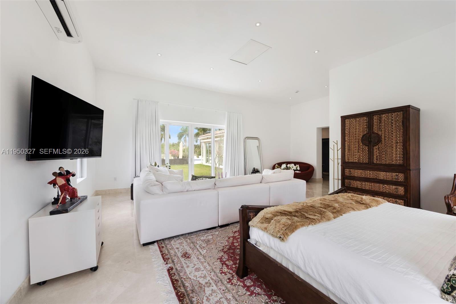 34650 Southwest 218th Avenue Homestead, FL 33034 - Photo 21 of 52 a bedroom with a bed and a flat screen tv