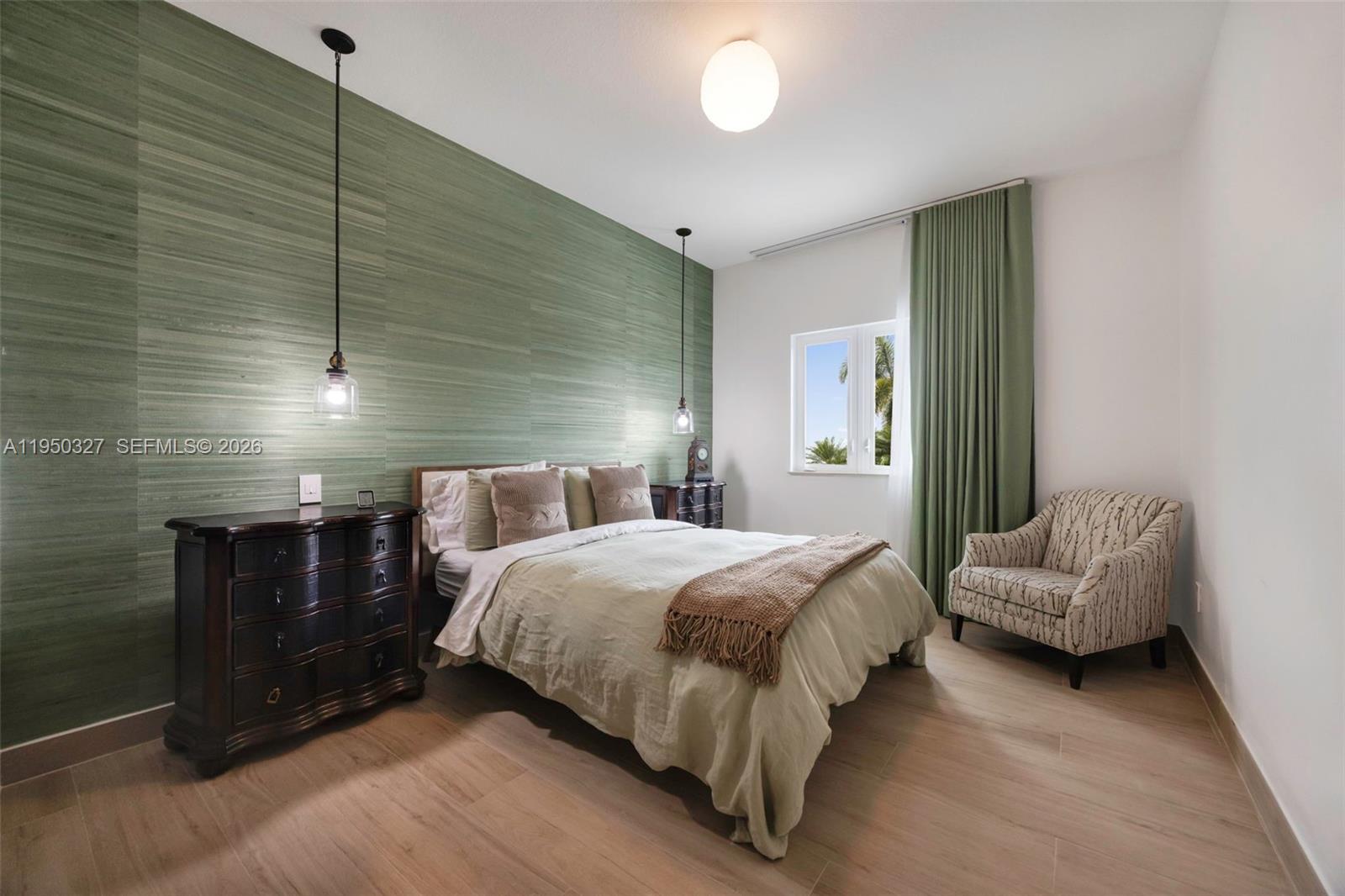 34650 Southwest 218th Avenue Homestead, FL 33034 - Photo 24 of 52 a bedroom with a bed and a chandelier