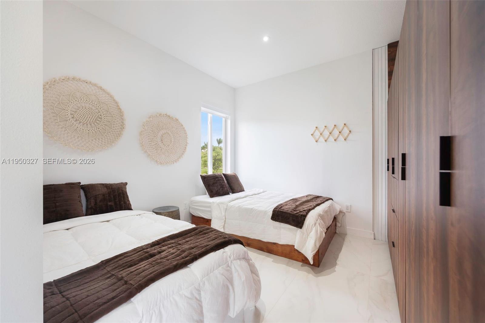 34650 Southwest 218th Avenue Homestead, FL 33034 - Photo 25 of 52 a bedroom with a bed and a lamp