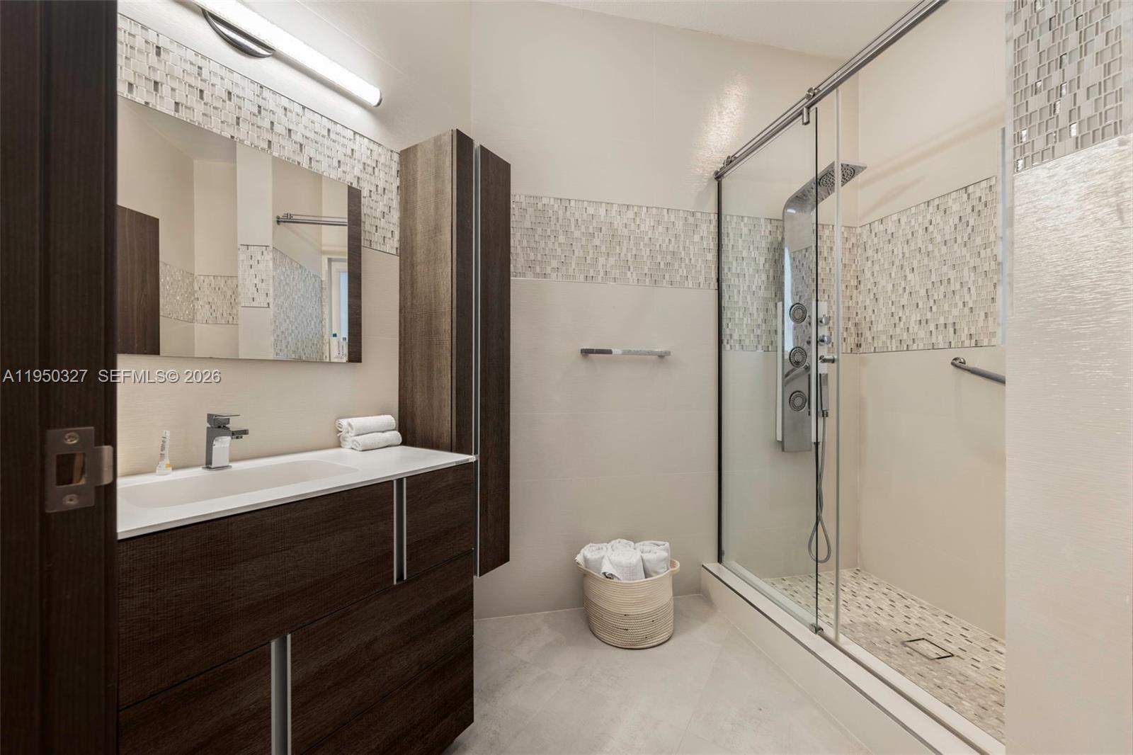 34650 Southwest 218th Avenue Homestead, FL 33034 - Photo 32 of 52 a bathroom with a double vanity sink toilet and shower