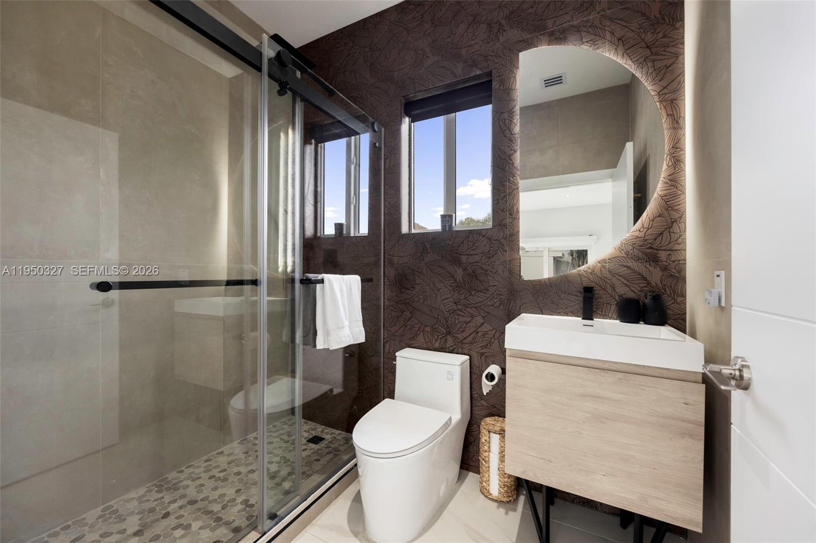 34650 Southwest 218th Avenue Homestead, FL 33034 - Photo 34 of 52 a white toilet sitting next to a bathroom sink and a shower