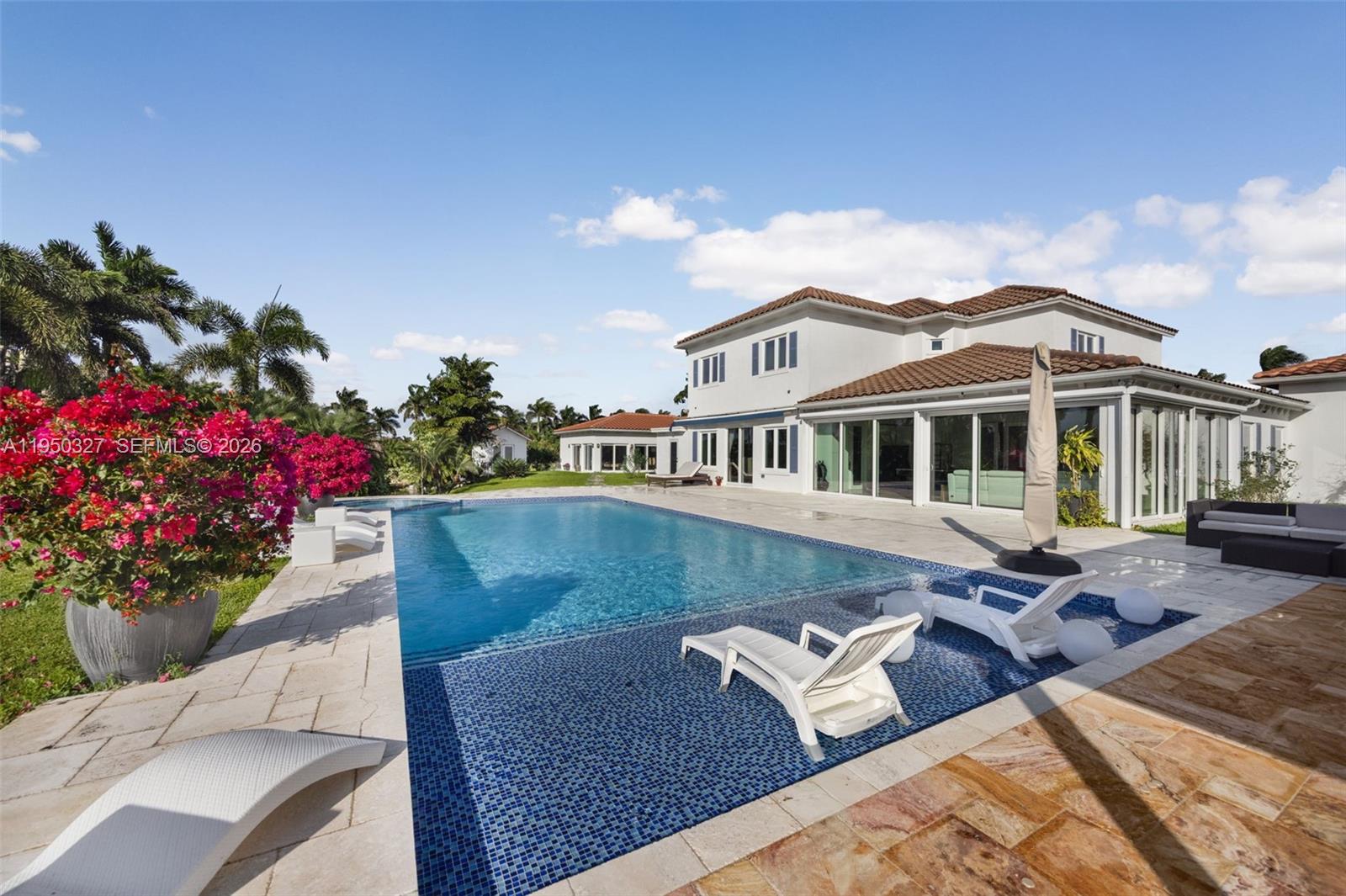 34650 Southwest 218th Avenue Homestead, FL 33034 - Photo 39 of 52 a front view of a house with a yard and balcony