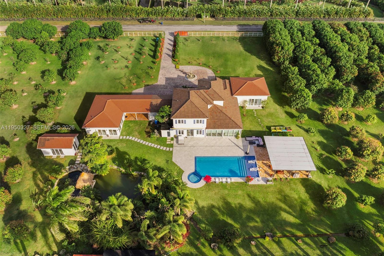 34650 Southwest 218th Avenue Homestead, FL 33034 - Photo 4 of 52 an aerial view of a house with a garden and lake view