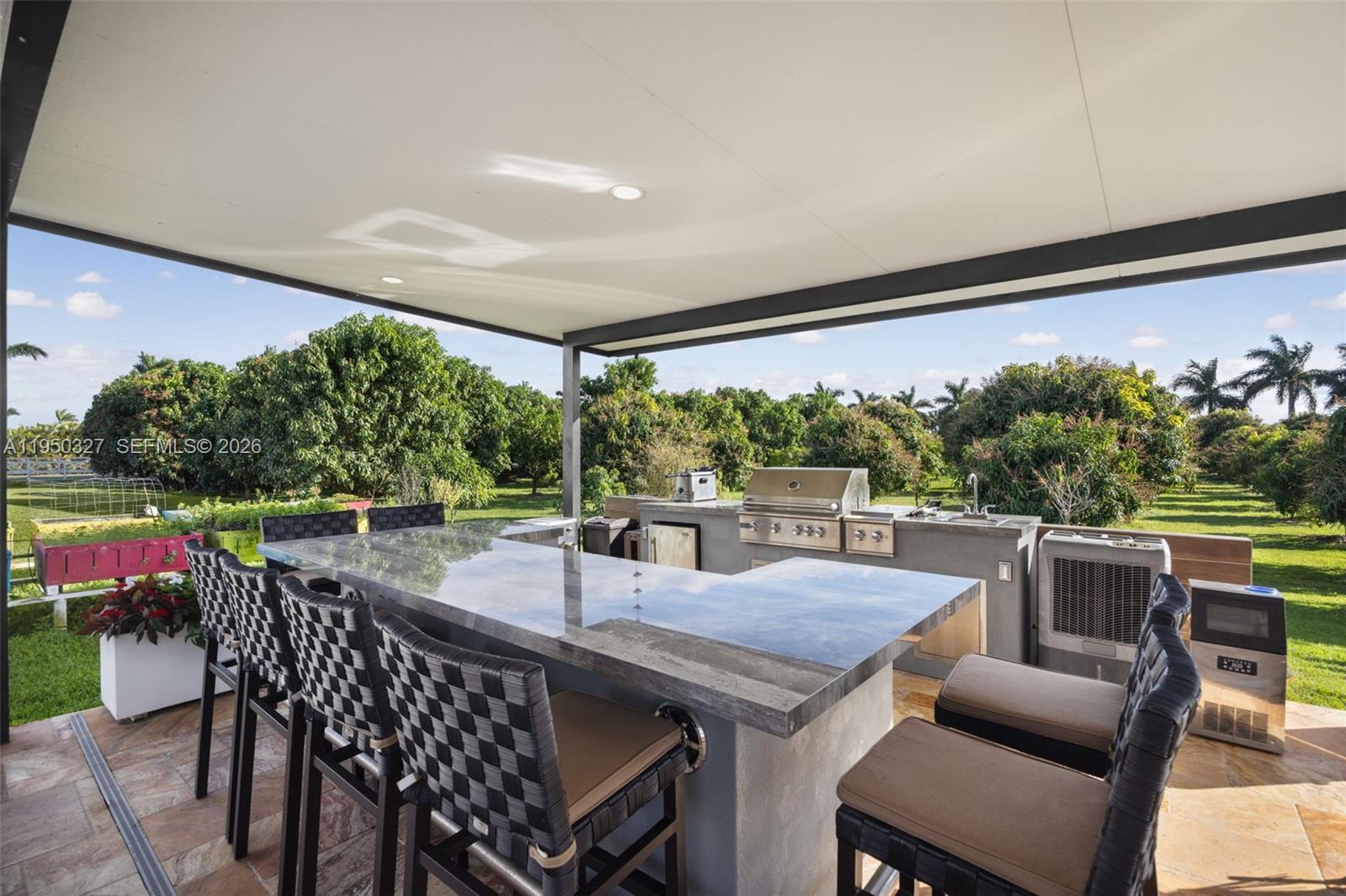 34650 Southwest 218th Avenue Homestead, FL 33034 - Photo 42 of 52 a view of an outdoor dining space with furniture and garden view