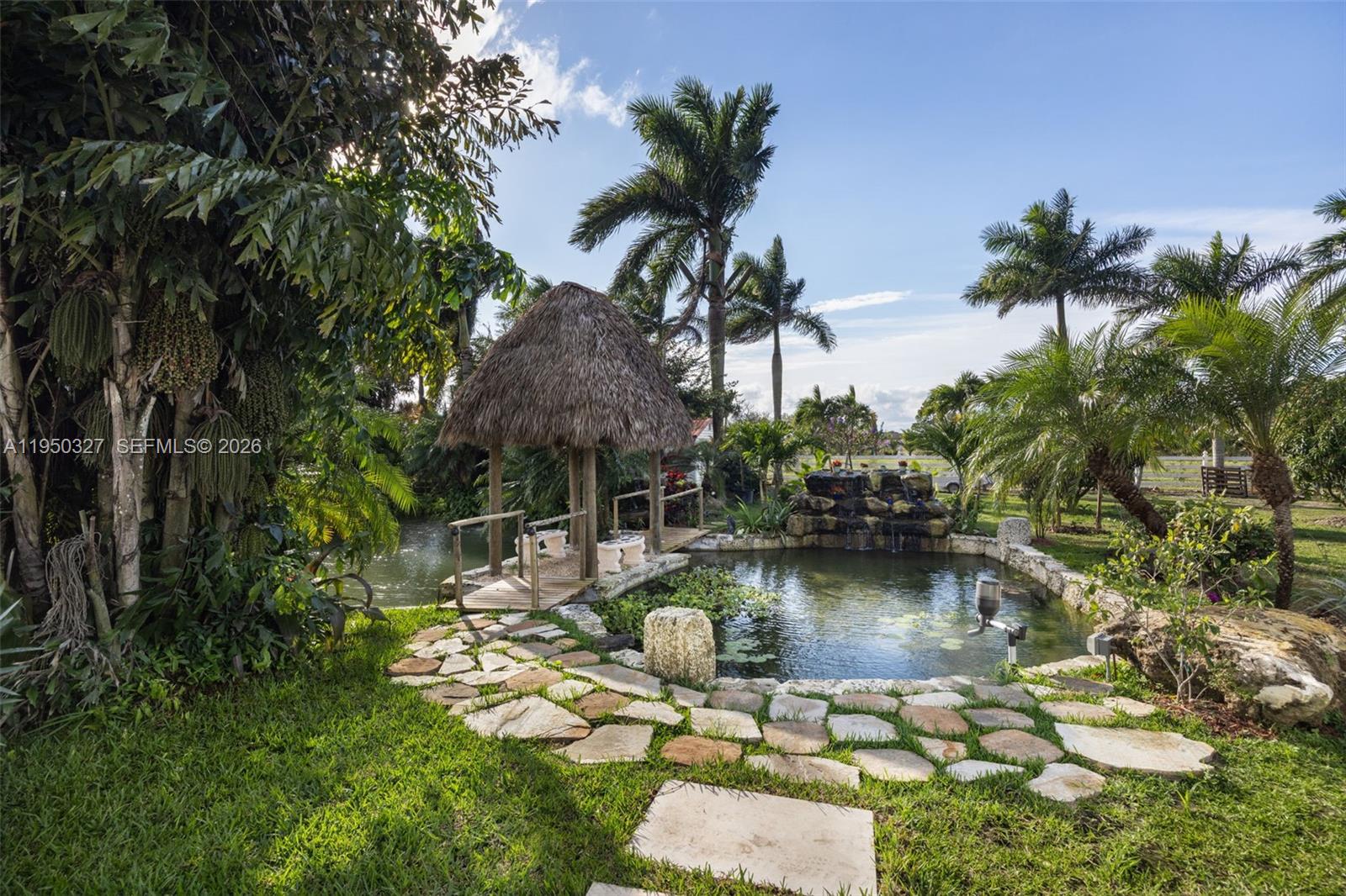 34650 Southwest 218th Avenue Homestead, FL 33034 - Photo 43 of 52 a swimming pool with outdoor seating and yard