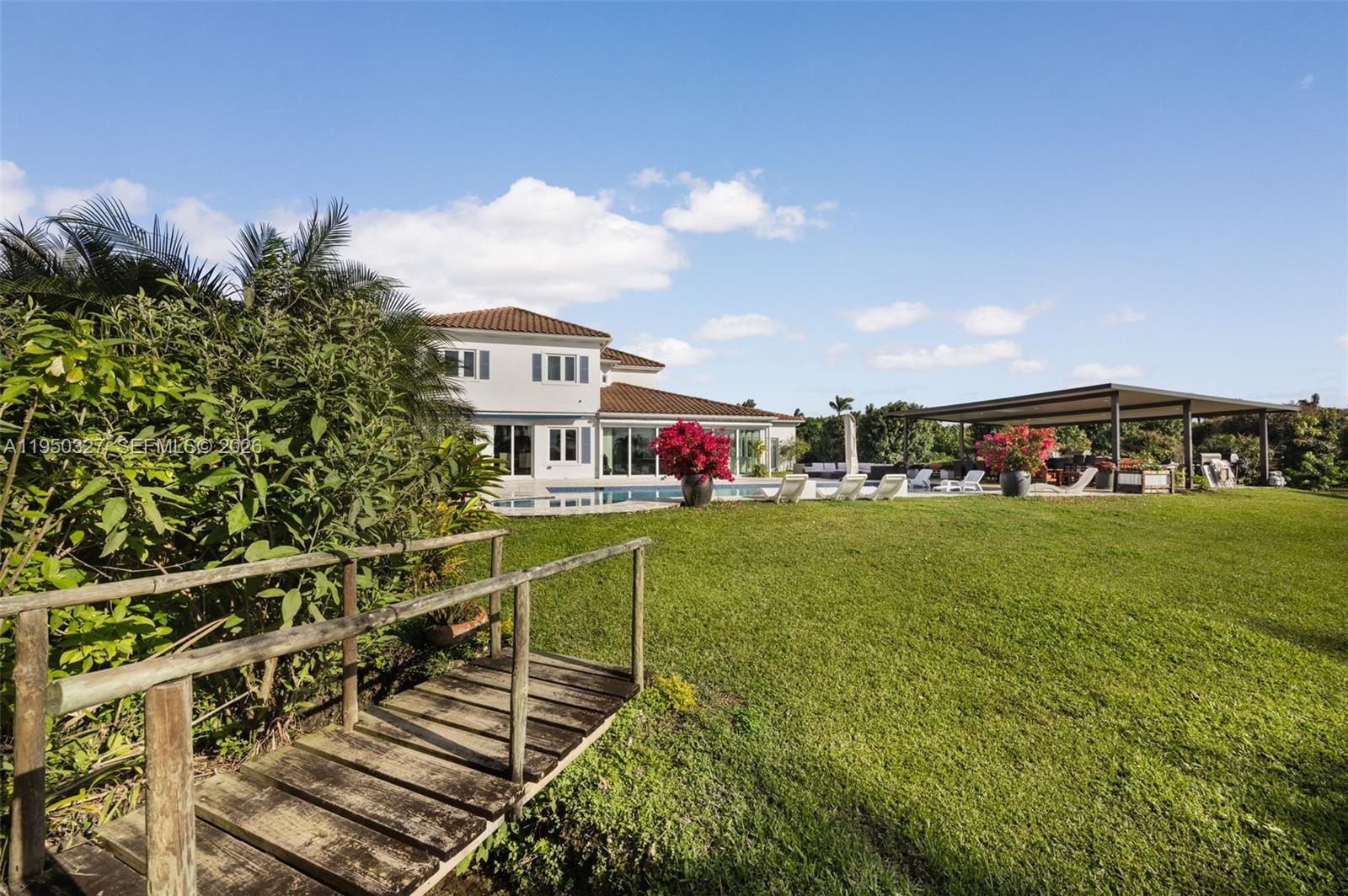 34650 Southwest 218th Avenue Homestead, FL 33034 - Photo 44 of 52 a front view of a house with a yard