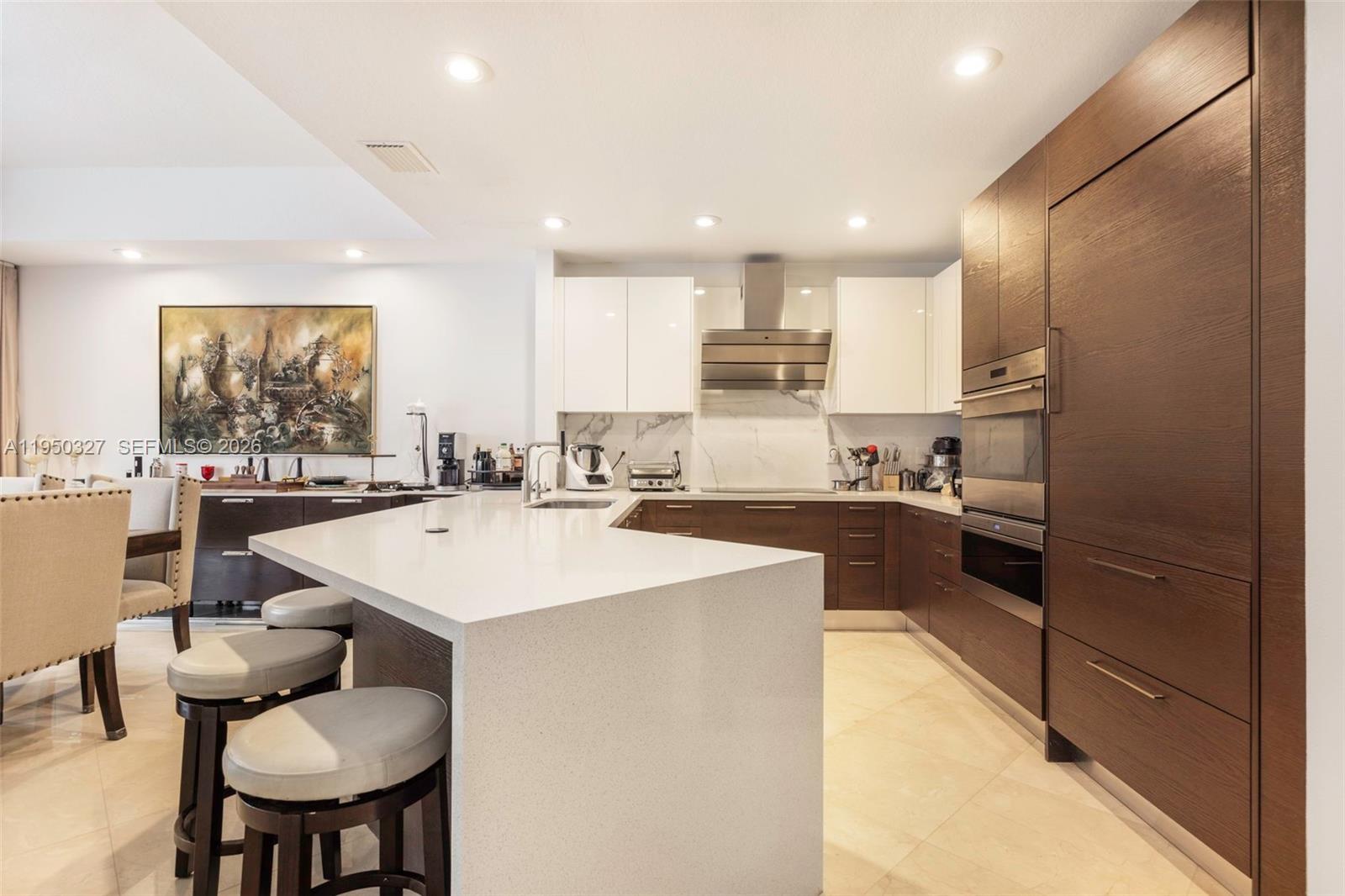34650 Southwest 218th Avenue Homestead, FL 33034 - Photo 9 of 52 a large kitchen with a large counter top space a sink stainless steel appliances and cabinets