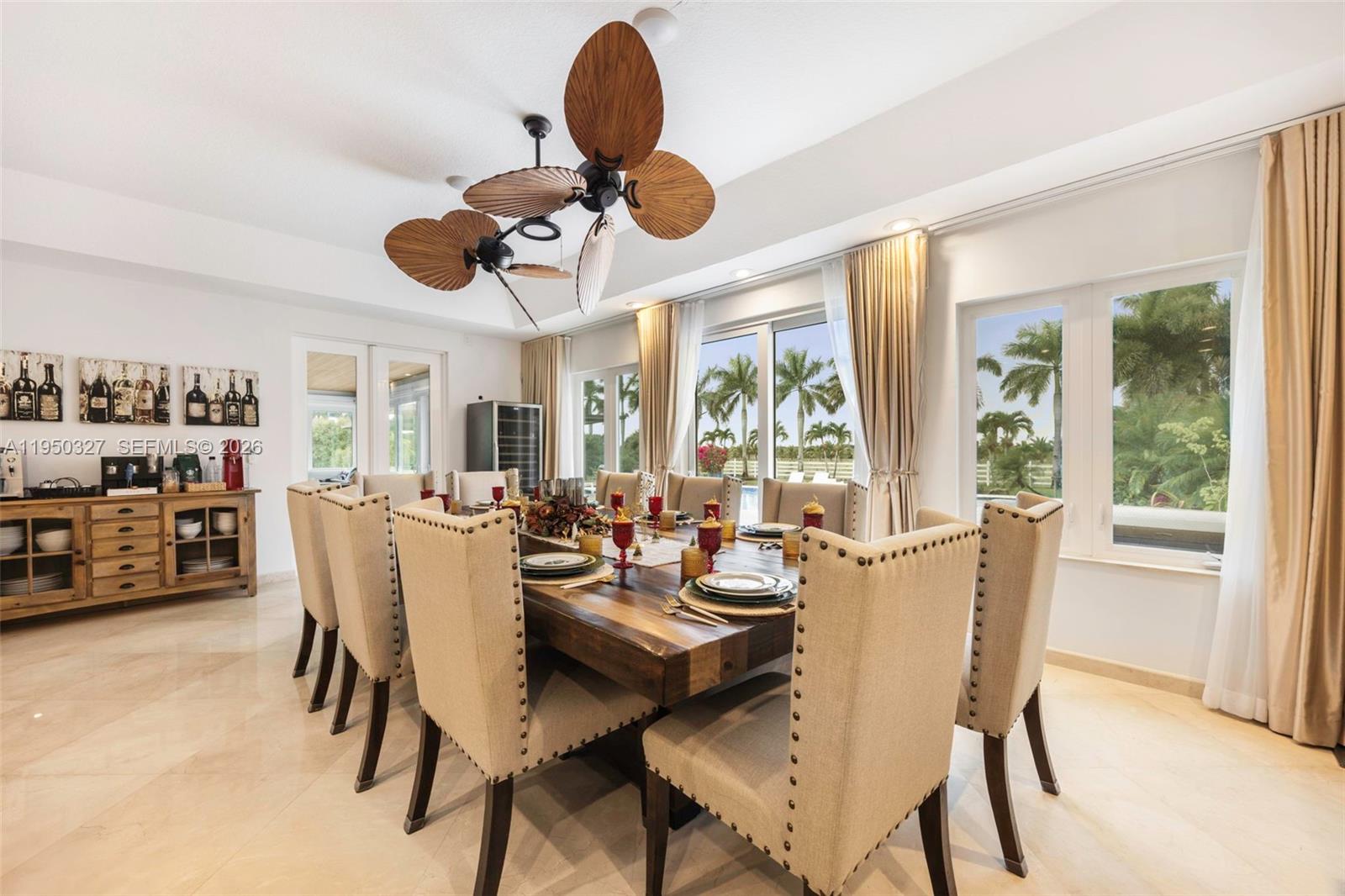 34650 Southwest 218th Avenue Homestead, FL 33034 - Photo 10 of 52 a dining room with wooden floor a chandelier a glass table and chairs