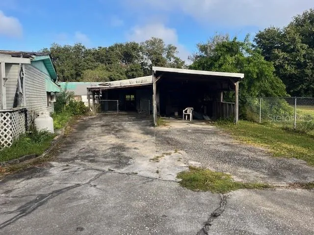a backyard of a house with yard and trampoline