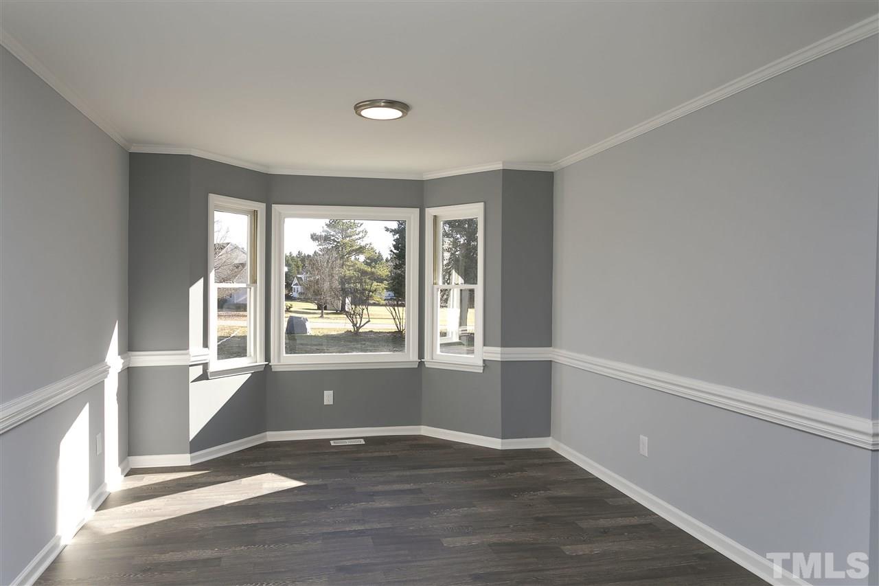 2016 Howson Road Raleigh, NC 27603 - Photo 12 of 25 an empty room with wooden floor and windows