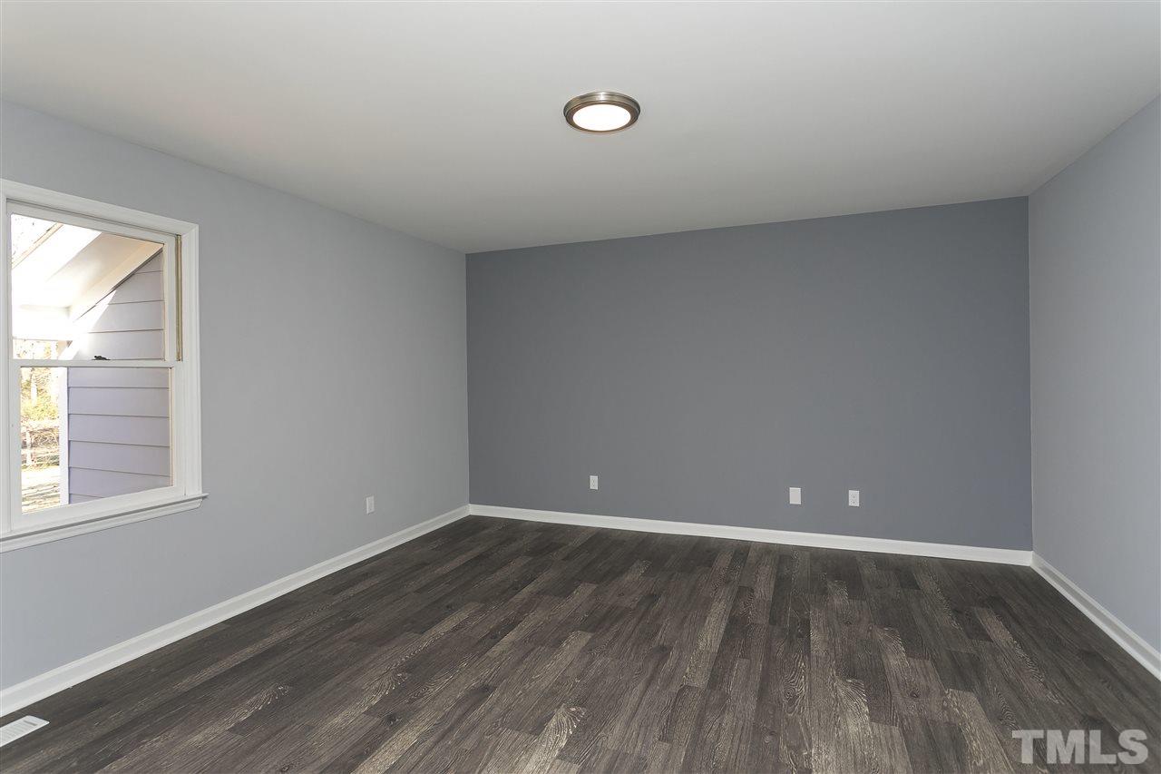 2016 Howson Road Raleigh, NC 27603 - Photo 15 of 25 a view of an empty room with wooden floor and a window