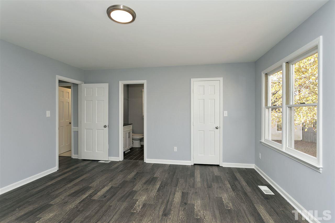 2016 Howson Road Raleigh, NC 27603 - Photo 16 of 25 an empty room with wooden floor and windows