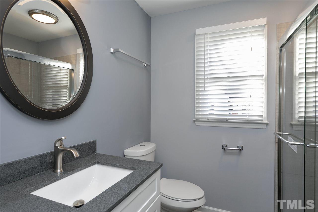 2016 Howson Road Raleigh, NC 27603 - Photo 17 of 25 a bathroom with a toilet a sink and a mirror
