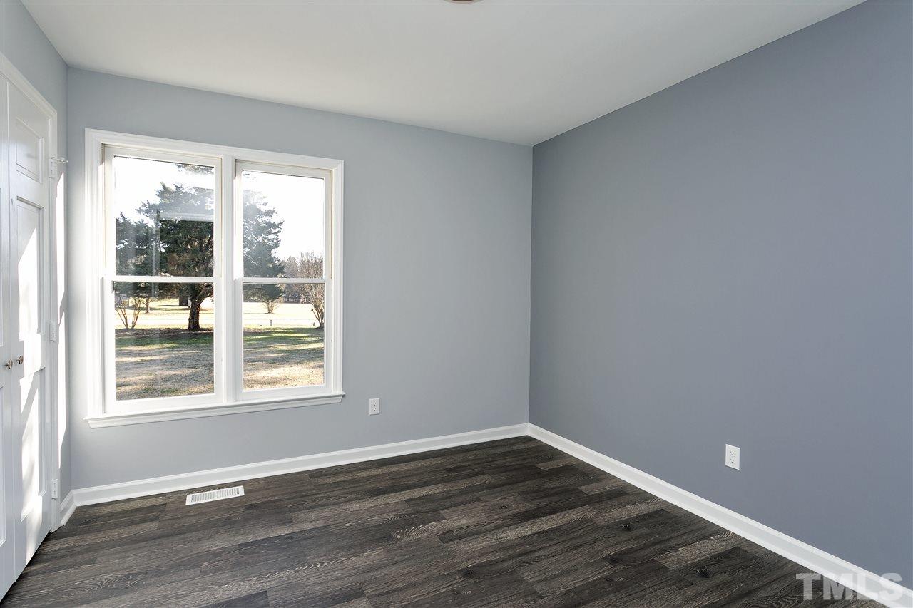 2016 Howson Road Raleigh, NC 27603 - Photo 19 of 25 a view of an empty room with wooden floor and a window
