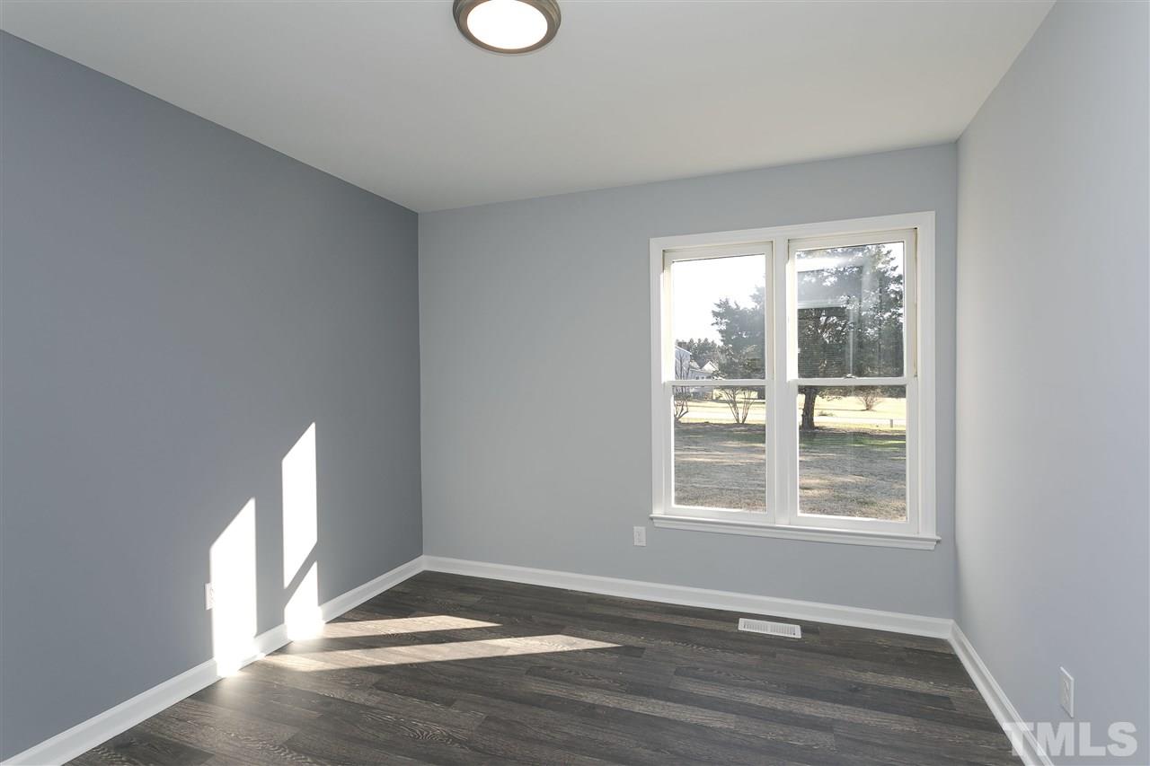 2016 Howson Road Raleigh, NC 27603 - Photo 20 of 25 a view of an empty room with wooden floor and a window