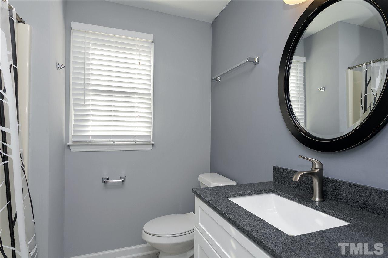 2016 Howson Road Raleigh, NC 27603 - Photo 21 of 25 a bathroom with a sink a mirror and a toilet