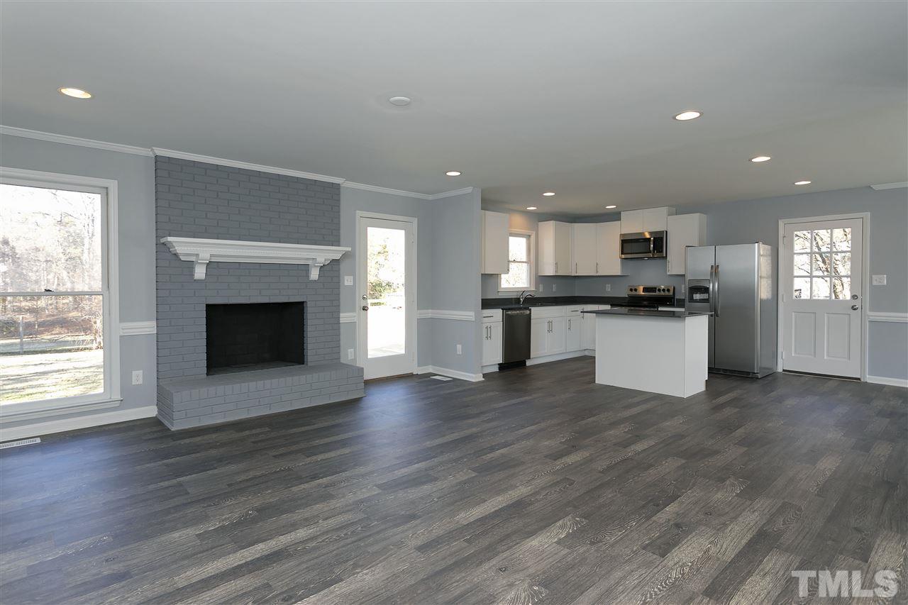 2016 Howson Road Raleigh, NC 27603 - Photo 5 of 25 an open kitchen with a sink stove and cabinets