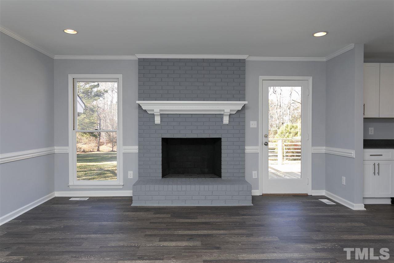 2016 Howson Road Raleigh, NC 27603 - Photo 6 of 25 a living room with a fireplace and a window