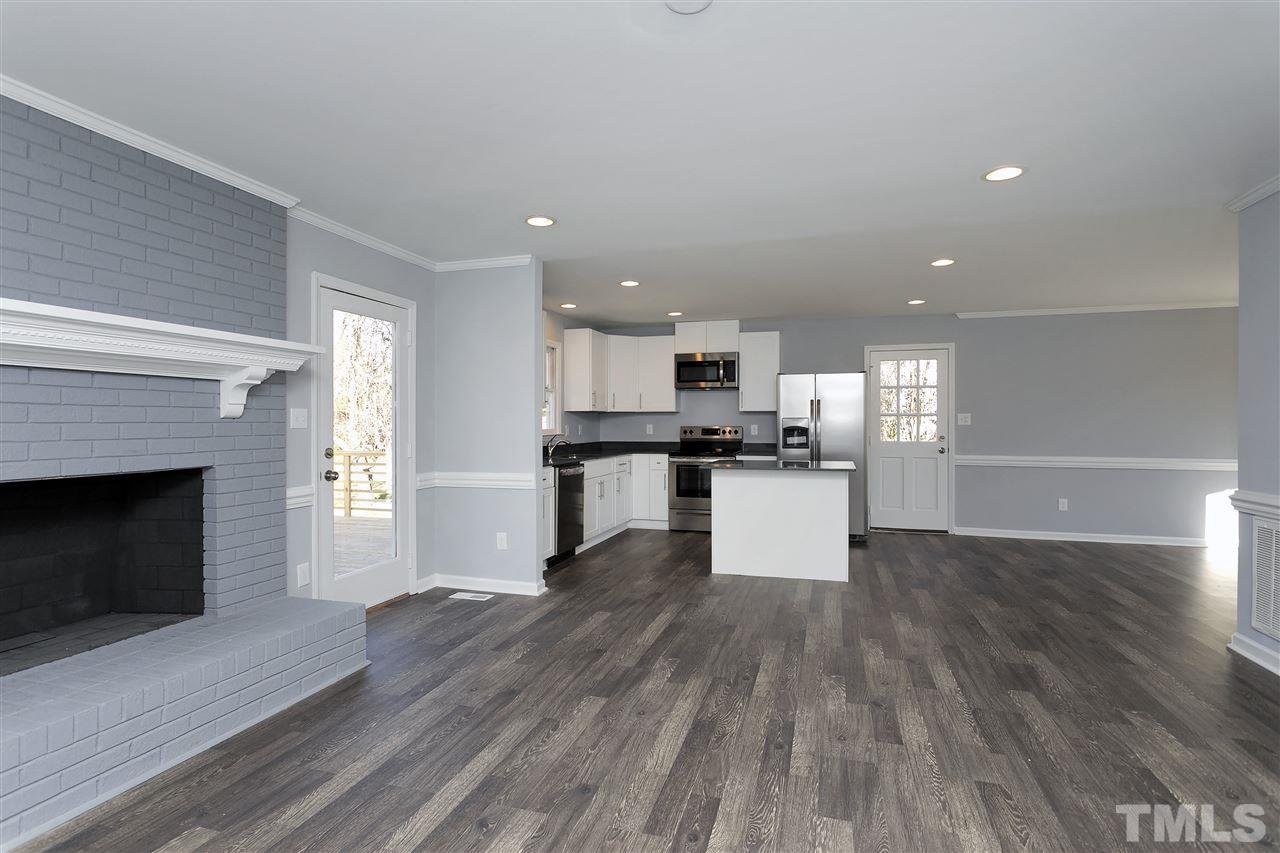 2016 Howson Road Raleigh, NC 27603 - Photo 7 of 25 a view of kitchen with wooden floor and a fireplace