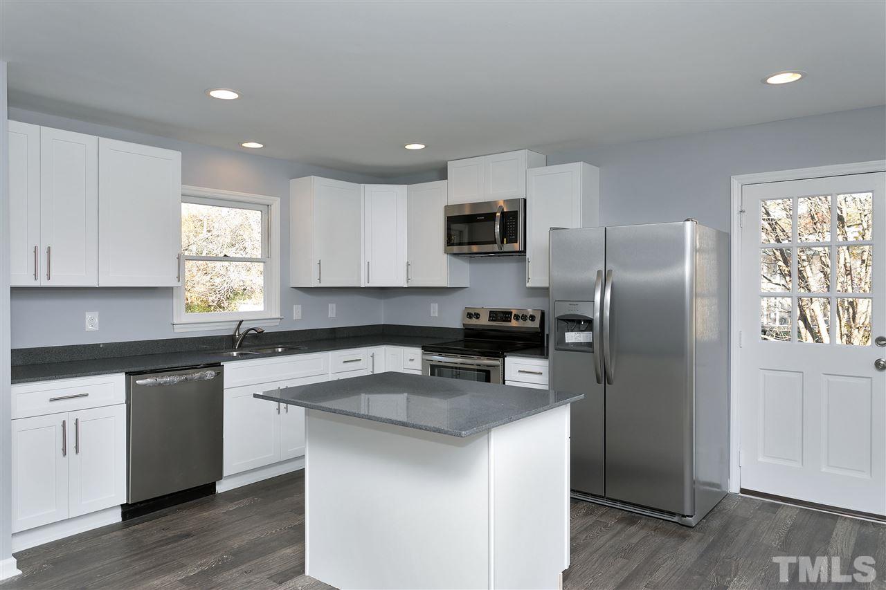 2016 Howson Road Raleigh, NC 27603 - Photo 9 of 25 a kitchen with kitchen island a sink stove and refrigerator
