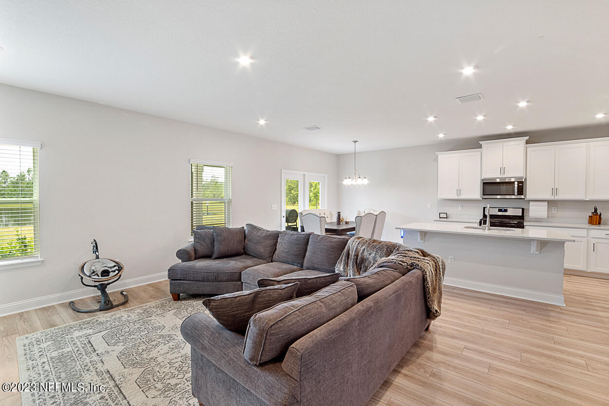 13186 Dunwick Road Jacksonville, FL 32256 - Photo 14 of 48 a living room with furniture and a wooden floor