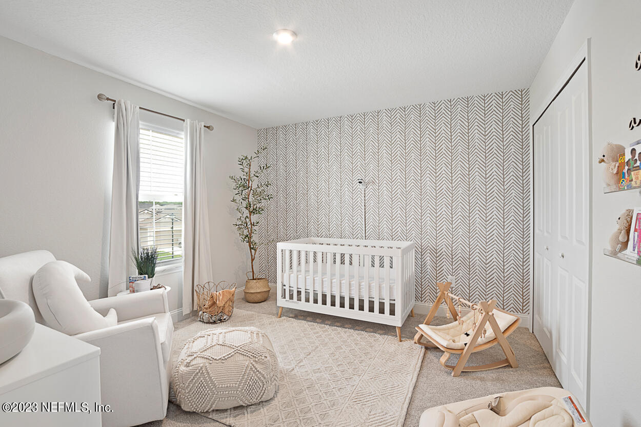 13186 Dunwick Road Jacksonville, FL 32256 - Photo 22 of 48 a bedroom with a bed and chair