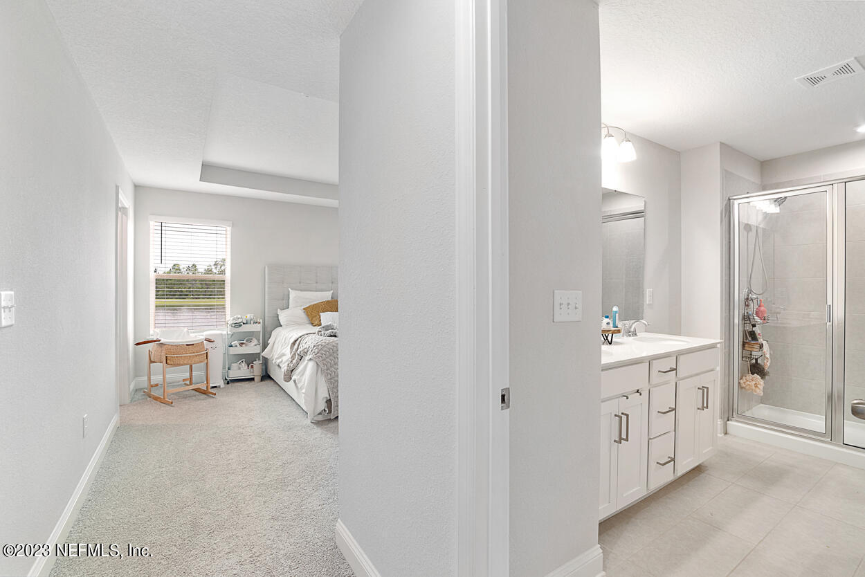 13186 Dunwick Road Jacksonville, FL 32256 - Photo 26 of 48 a en suite bathroom with a double vanity sink and mirror