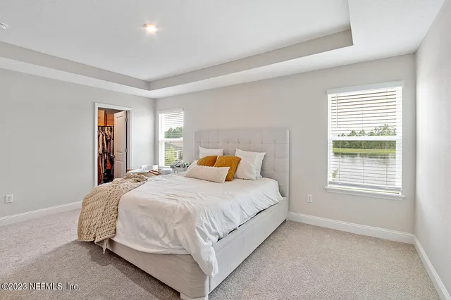 a bathroom with double vanity and a mirror