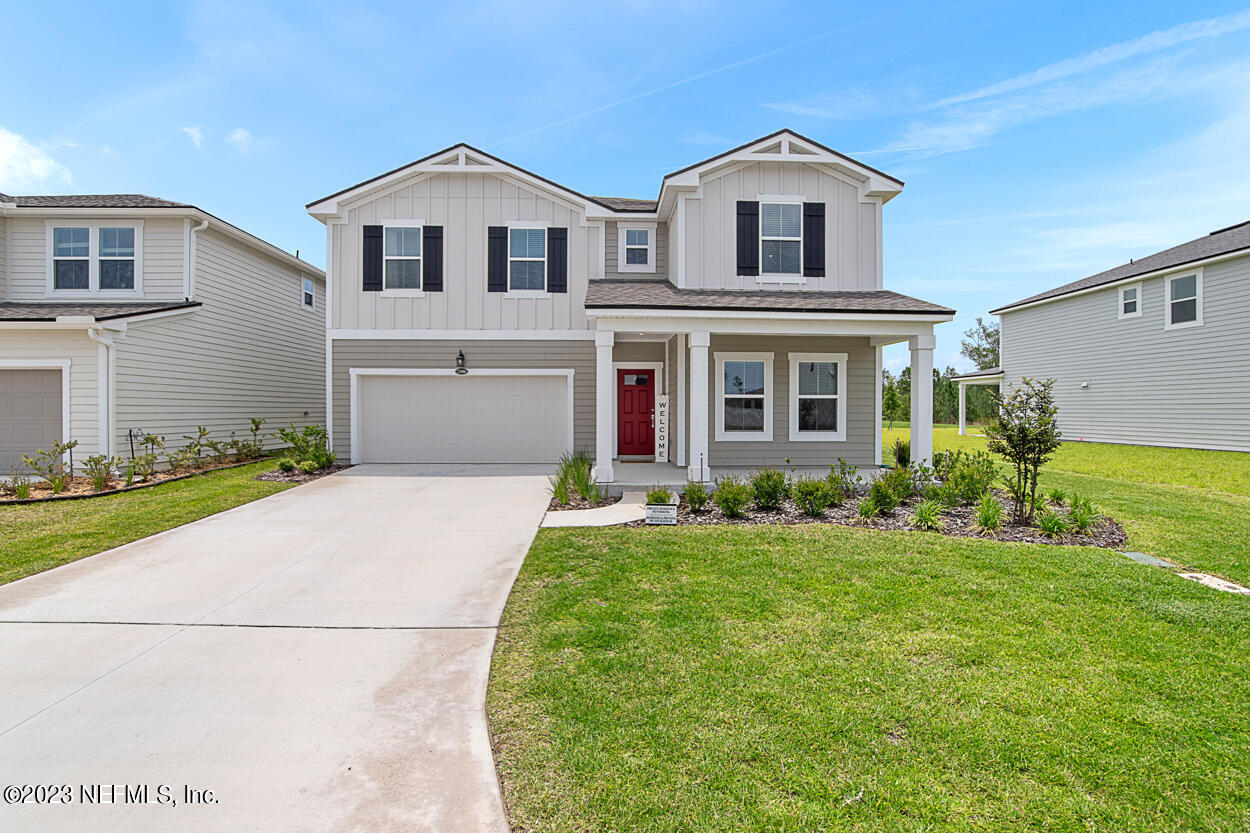 13186 Dunwick Road Jacksonville, FL 32256 - Photo 38 of 48 a front view of a house with a yard and garage