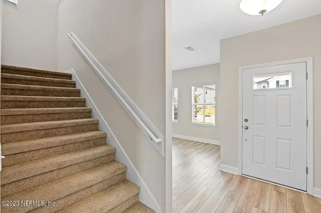 a view of an entryway with wooden floor