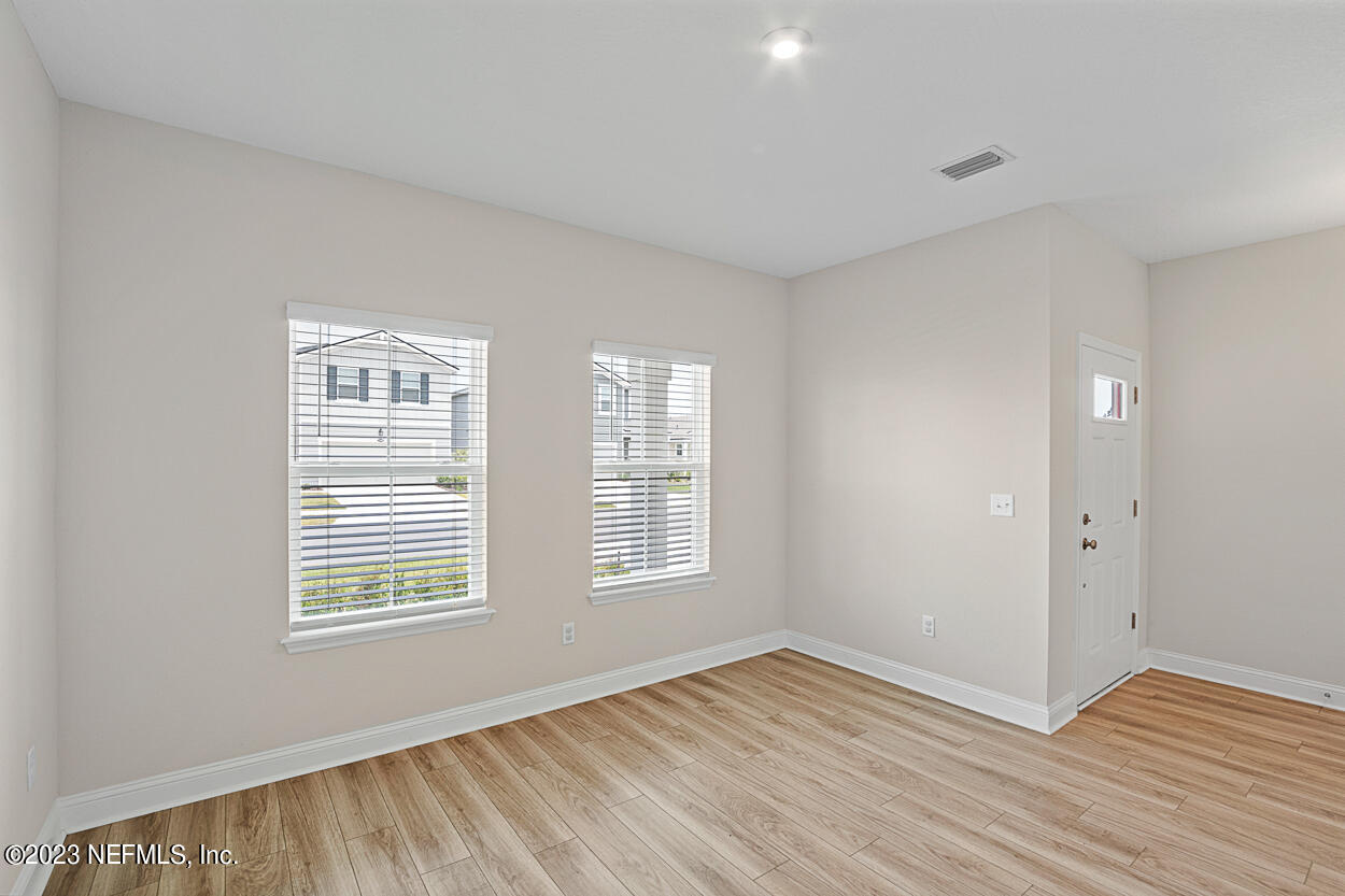 13186 Dunwick Road Jacksonville, FL 32256 - Photo 5 of 48 a view of an empty room with wooden floor and a window